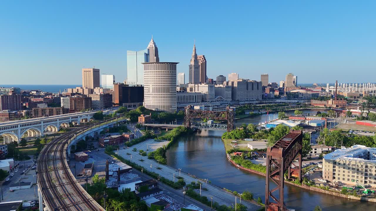 Downtown Cleveland with rail tracks in Irishtown Bend Neighborhood over Cuyahoga River, USA