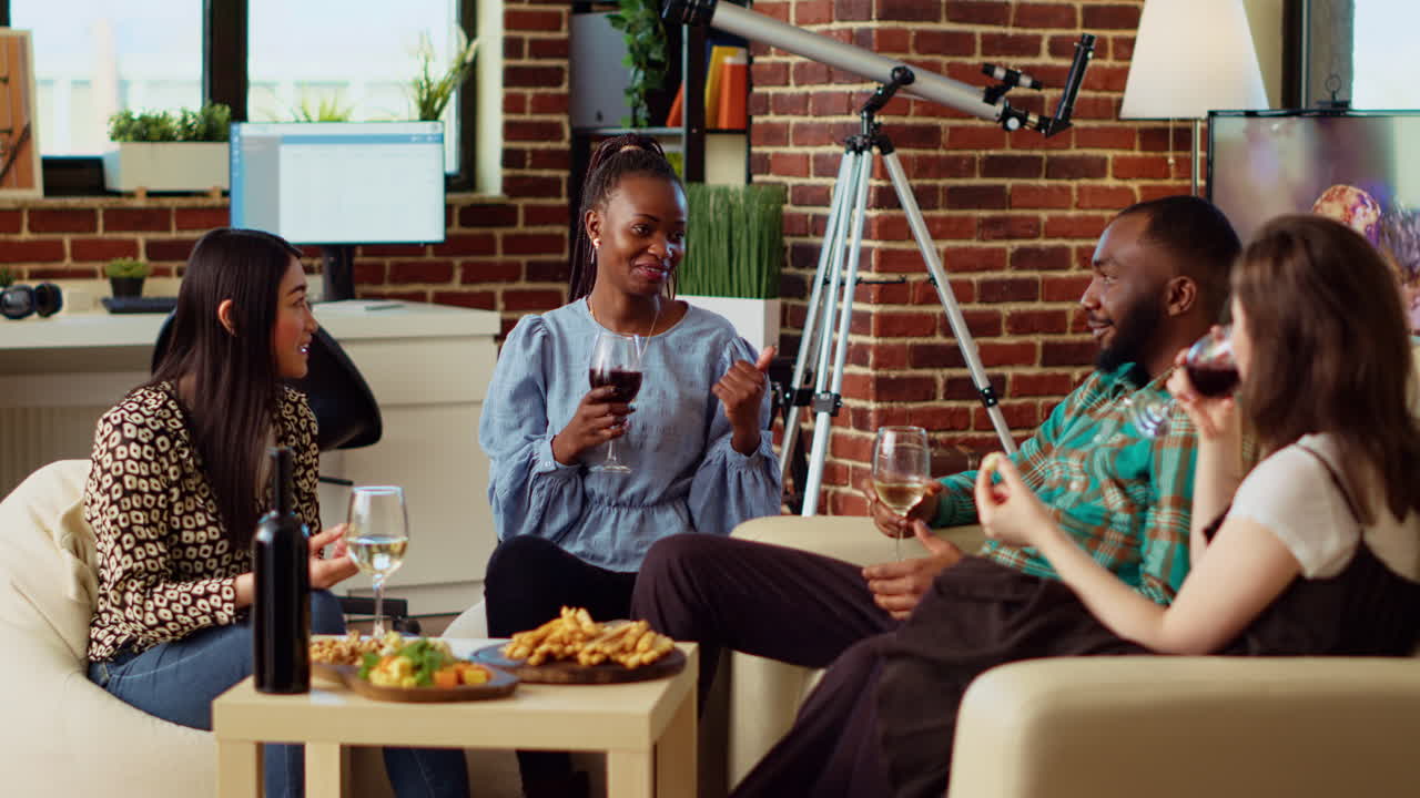 Multiracial friends at apartment party paying attention to interesting story shared by woman