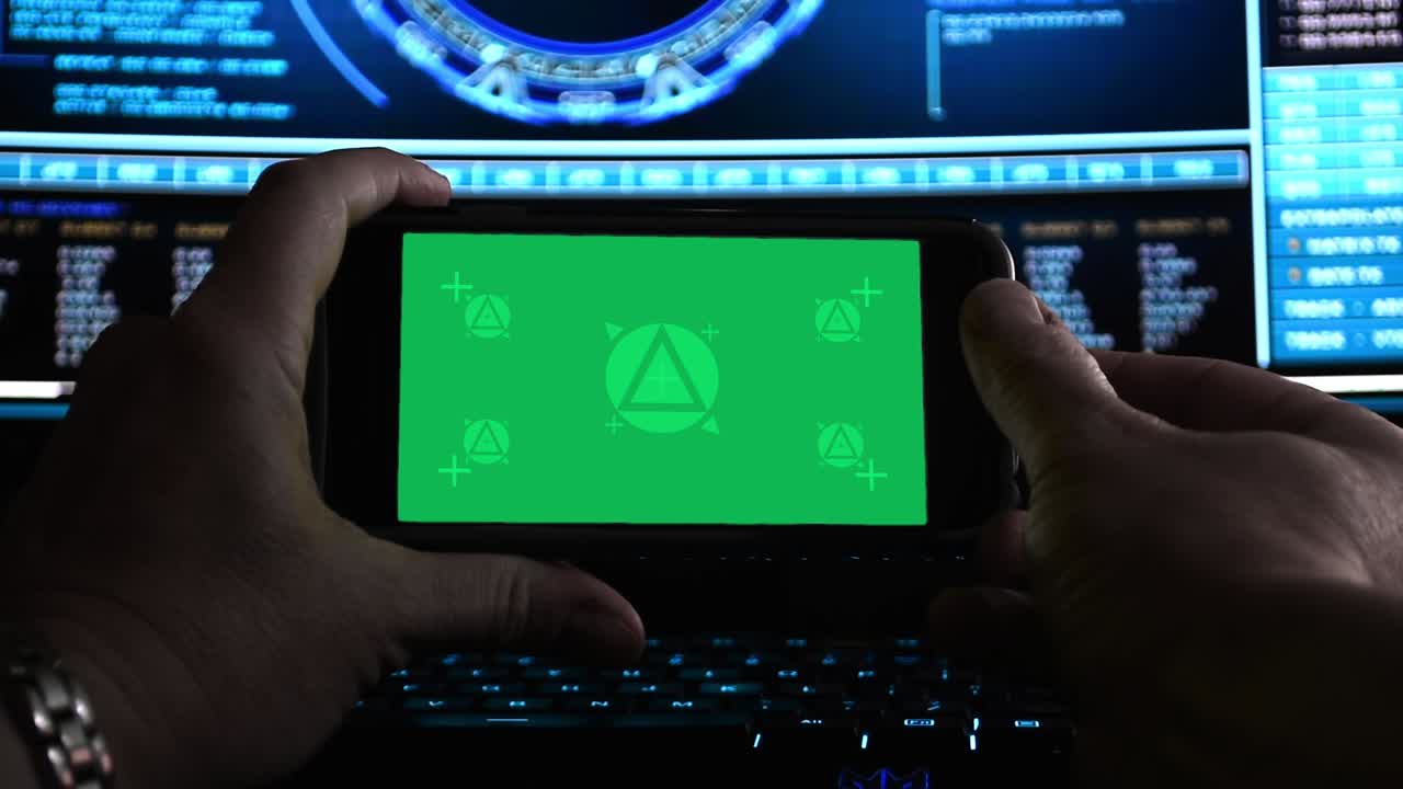 Hackers hands using a smartphone in dark office, motion-tracked for easy screen replacement