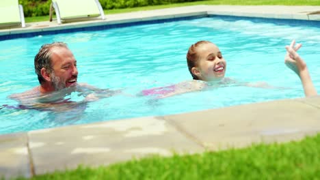 Family-enjoying-in-swimming-pool-
