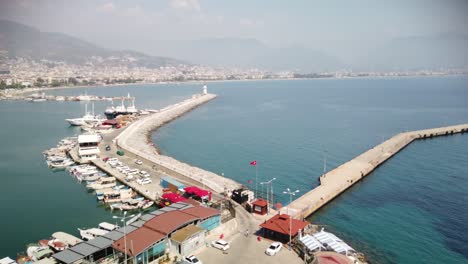 view of alanya and harbour at a sunny day. shore of mediterranean sea and historical alanya shipyard in turkey.