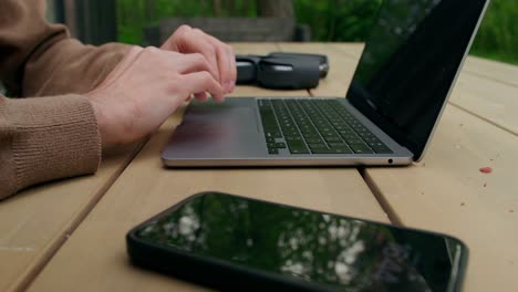 outdoor workspace with laptop, drone, and smartphone