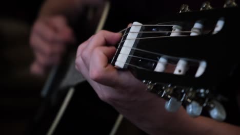 close-up of hands playing a classical guitar