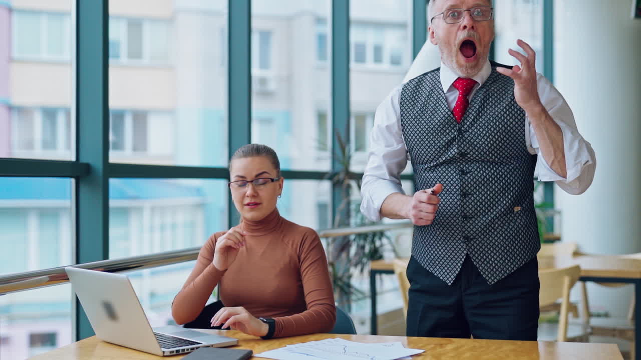 Secretary and her mature boss in office. Senior businessman puts document on the desk angrily and feels ashamed. Slow motion.