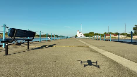 drone taking off of the stone pier in late summer