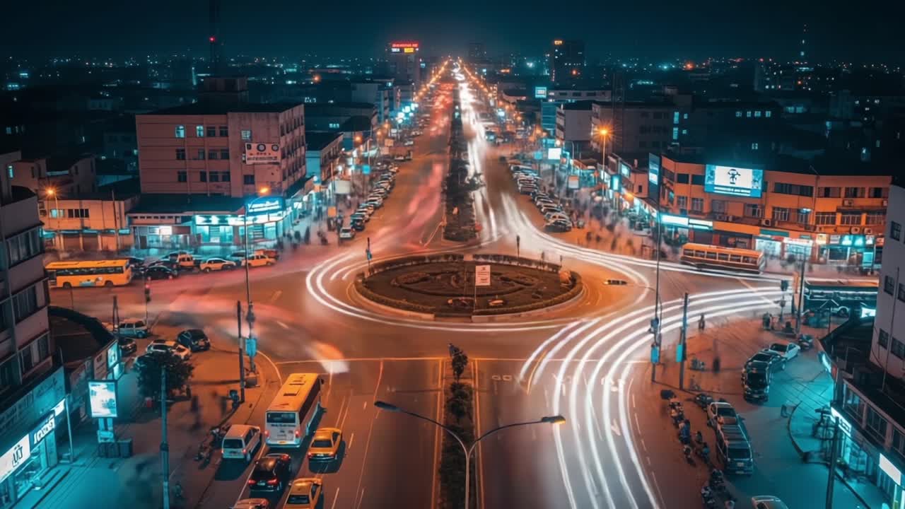A Vibrant Nighttime Cityscape Highlighting Busy Urban Intersection with Flowing Traffic and Illuminated Streets in a Bustling Metropolitan Environment