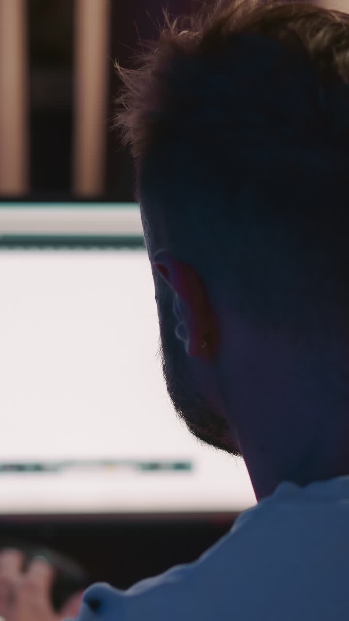 Sound producer works on computer closeup. Skillful man crafts put tracks together at workstation. Artistic efforts of determined music director