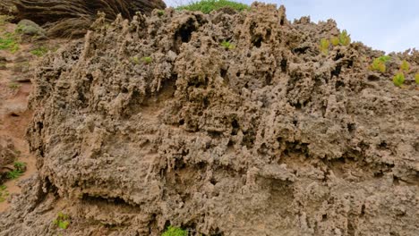 pan up of eroded limestone cliffs and sky