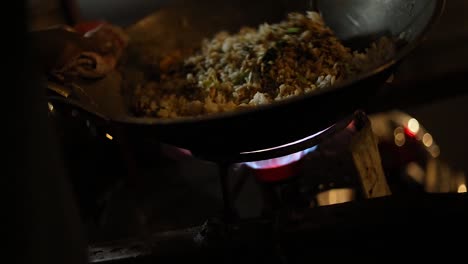 shot of a street vendor cooking their indonesian food to sell by deep frying it in a bowl of cooking oil