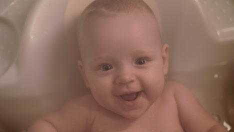 cute cheerful baby bathing