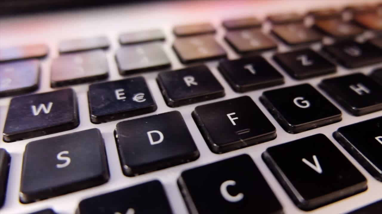 Close up of a black laptop keyboard in daylight