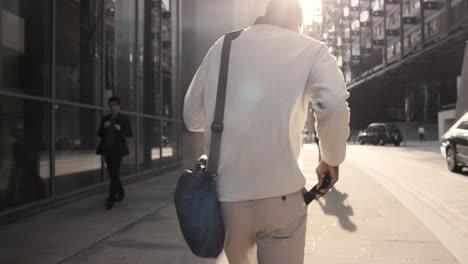 Rear-view-african-american-businessman-walking-in-city