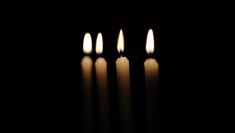 lit candles on black background