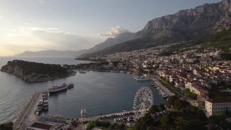 Beautiful-Sunset-Over-Makarska-Harbor-And-The-Adriatic-Sea-In-Croatia,-Aerial-Tracking-Shot