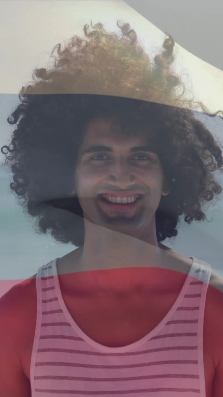 Animation of russian flag waving over smiling man standing on beach against sea