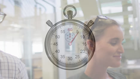 animation of ticking stopwatch over diverse man and woman discussing while climbing stairs at office