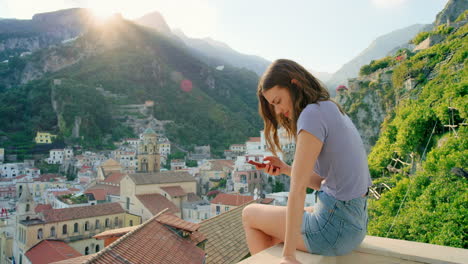 woman using phone with stunning view