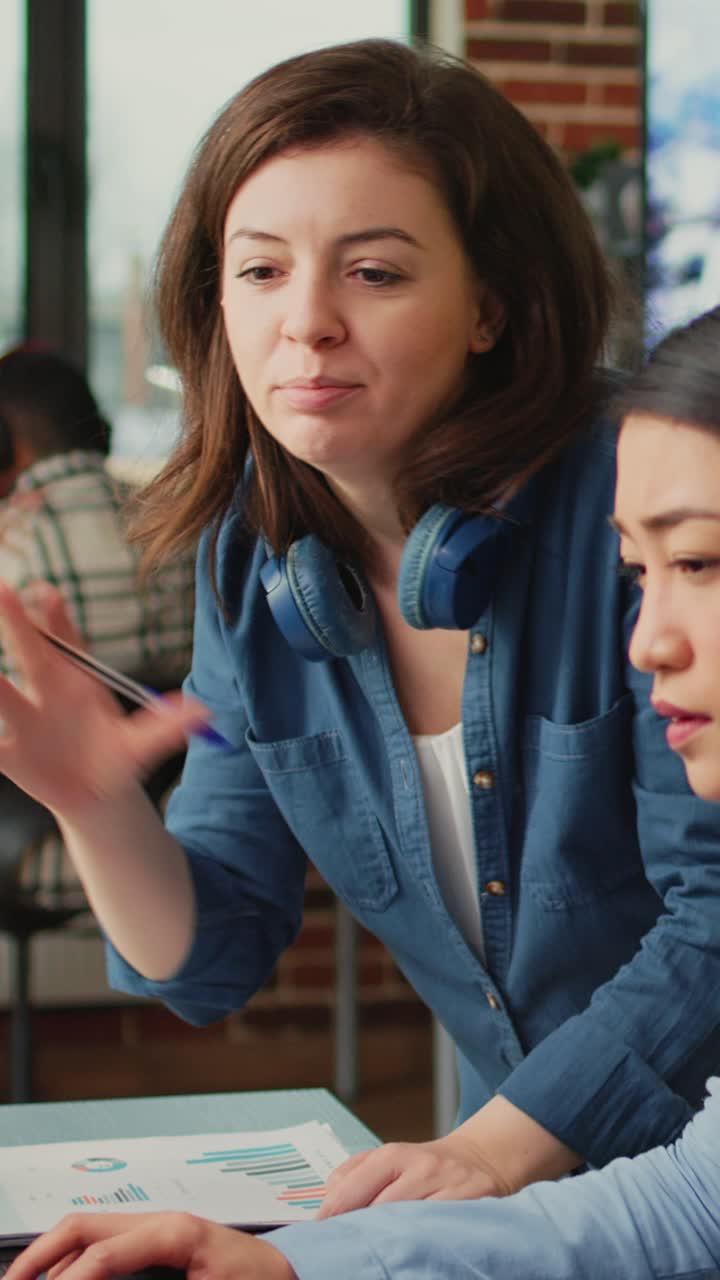 Vertical video: Team of colleagues brainstorming ideas to develop professional content