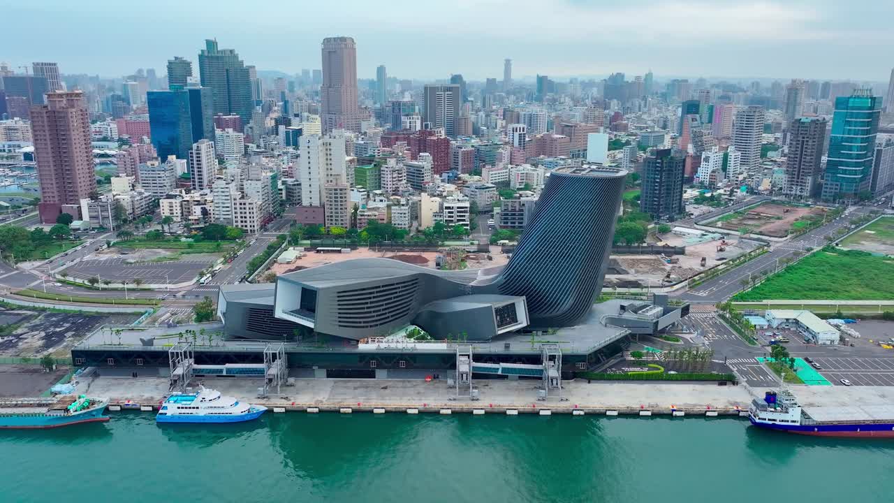 Aerial approaching shot of Cruise Terminal and Skyline of Kaohsiung City during sunny day in Taiwan