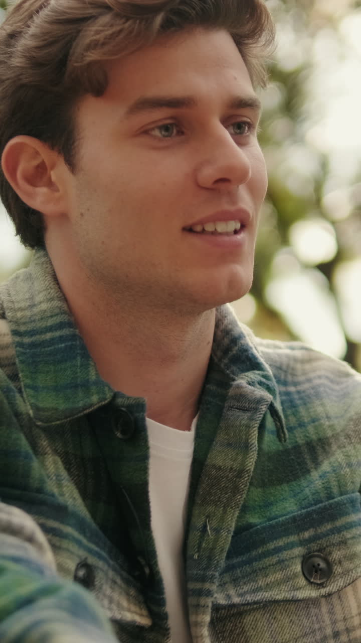 Close-up of young smiling man looking at his girlfriend