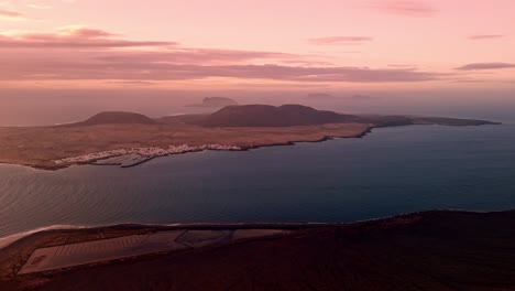 breathtaking aerial drone footage captured at sunset from el mirador del río of la graciosa island in lanzarote, canary islands, spain.