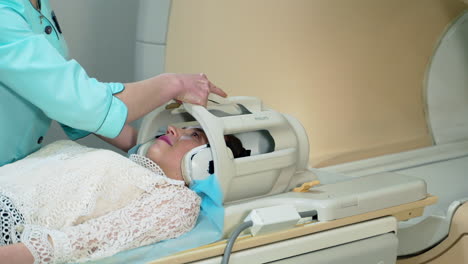 patient lying on the tc scanner. patient being scanned and diagnosed on mri scanner