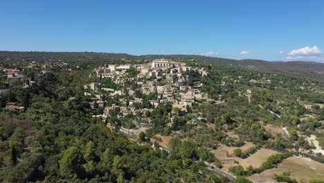 Famous-village-Gordes-natural-regional-park-Luberon-aerial-view-sunny-day-hotels