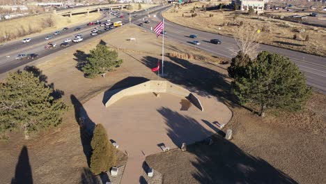 an orbital drone shot over a marine memorial, golden colorado