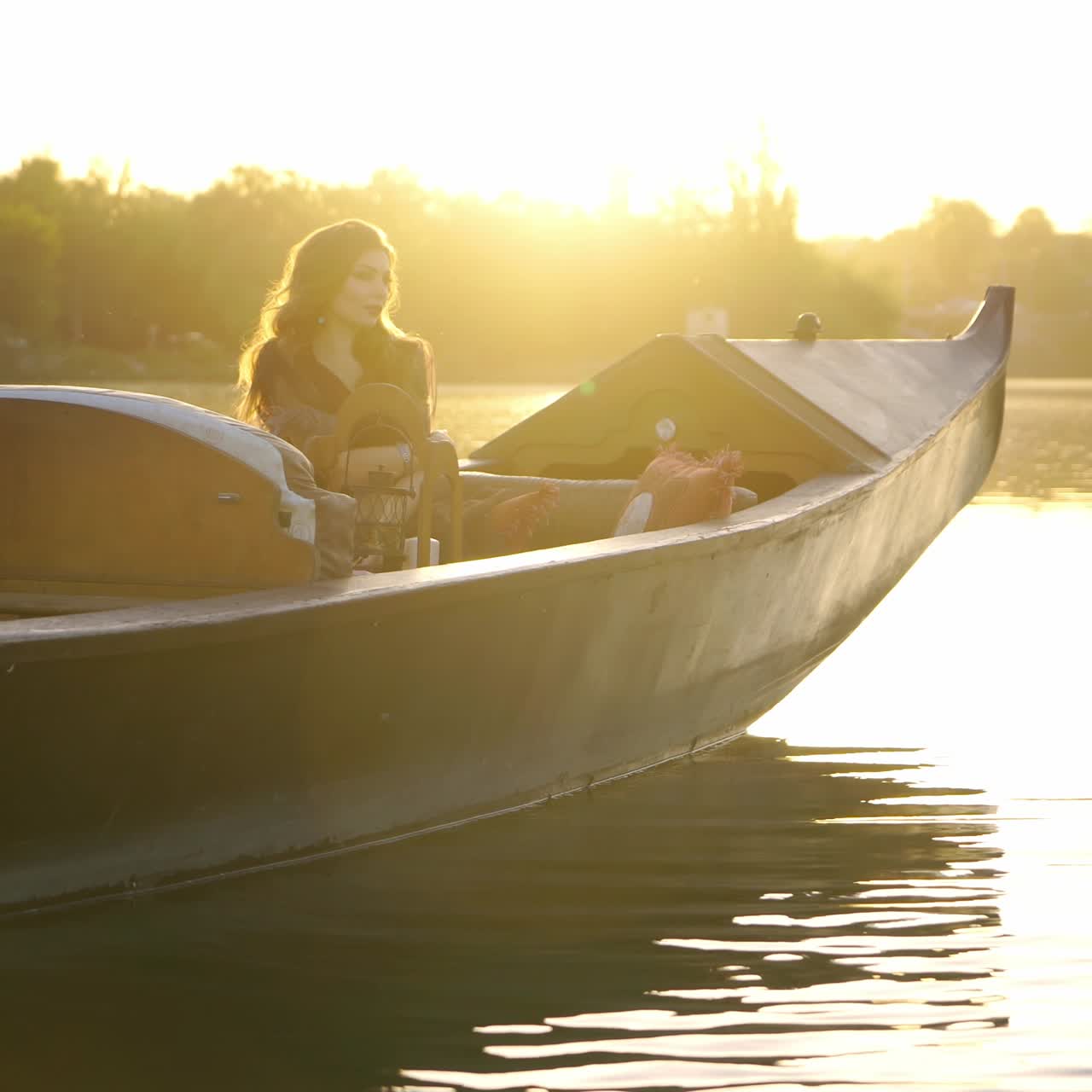 Girl sailing on a gondola down the river. Beautiful woman with carnival mask