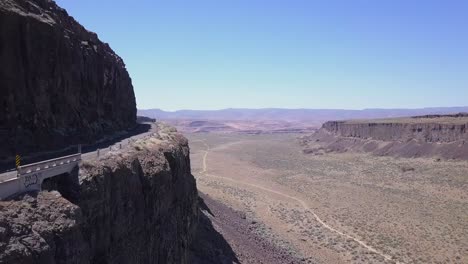 cliff aerial: road carved into rock wall of frenchman coulee, wa state