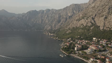 the old mediterranean port of kotor is surrounded by fortifications built during the venetian period and is located on the bay of kotor