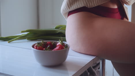 fitness body concept, eating healthy on kitchen table in red underwear