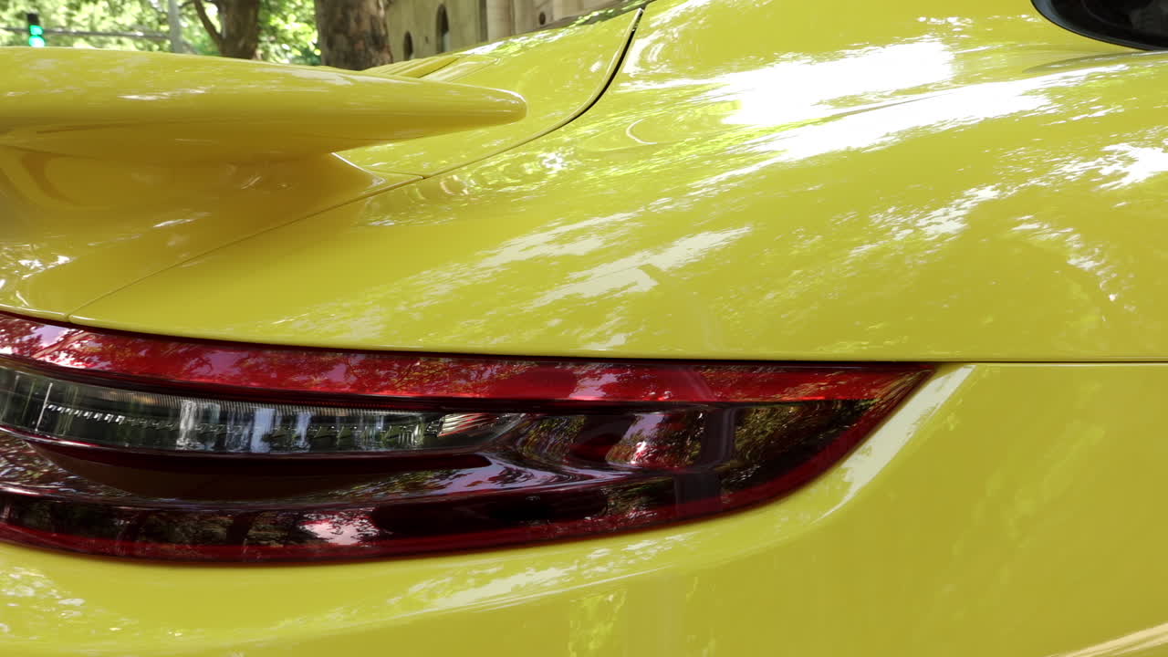 Close up of the stop lights of a yellow car on the street
