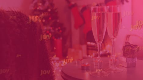 Animation-Von-Joy-Text-Auf-Rot,-über-Zwei-Gläsern-Champagner,-Mit-Weihnachtsgeschenken-Und-Dekorationen