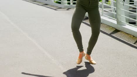 beautiful young dancer practicing dance on the bridge in the city 4k