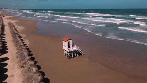 Discover-the-tranquility-of-this-stunning-sandy-beach,-captured-in-4K-with-smooth-drone-footage-panning-left-to-right