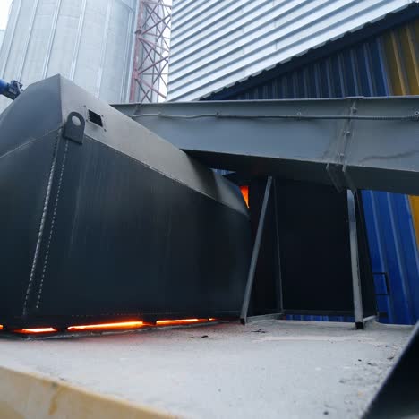 huge hearth with burning fire inside. flashes of fire seen in the gaps of the hearth. furnace place among the granary industrial premises