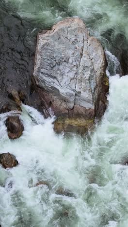 dynamic white water rapids surging powerfully through a rugged rocky river canyon in british columbia, canada.
