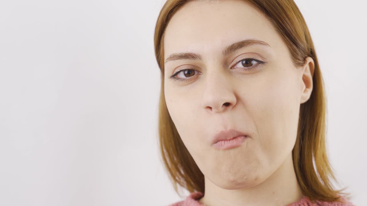 Close-up of woman eating dragee. Eating chocolate.
