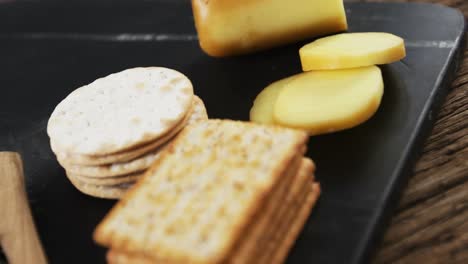 sliced cheese with crispy biscuits, seeds, rosemary herb and sauce