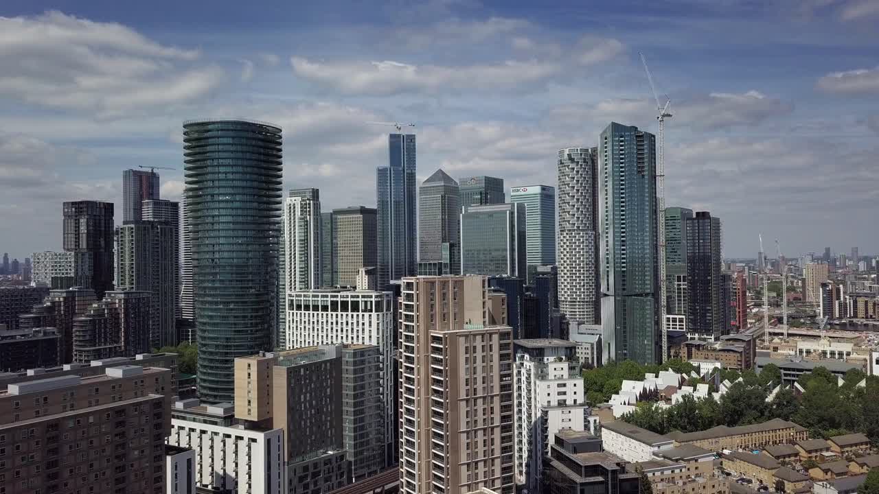 Aerial drone view of camera going up and revealing the buildings in Canary Wharf London during daytime