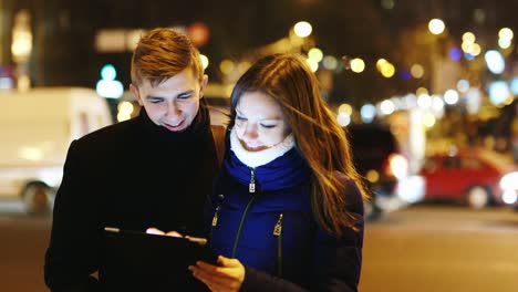 A-young-couple-uses-a-tablet-for-directions-2
