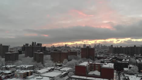 Combing-the-rooftops-of-Brooklyn,-NY's-East-Williamsburg,-this-aerial-shot-explores-the-skies-right-after-a-large-snow-storm