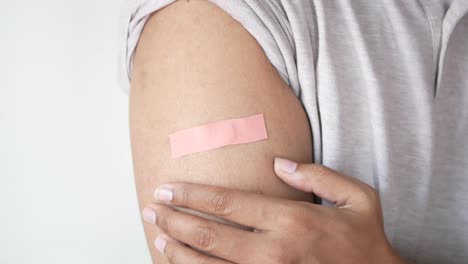 arm with bandage after vaccination