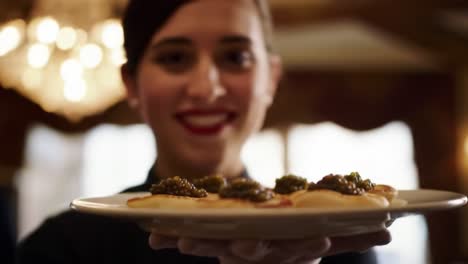 a culinary delight: a chef presenting exquisite appetizers topped with caviar on a beautifully crafted platter in an elegant setting