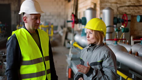 two co-workers talking at work