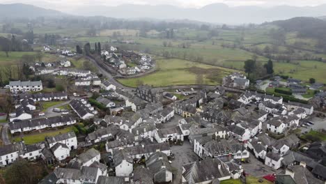 cinematic aerial drone footage of hawkshead village and st michael and all angels church