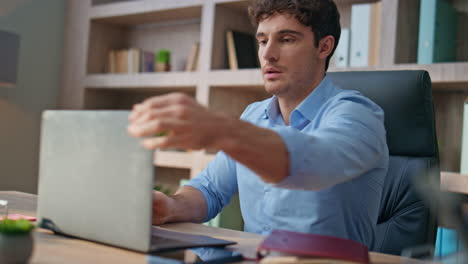 office man put coffee on desk closeup. focused manager working opening computer
