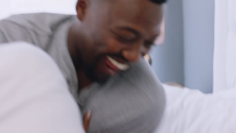 Happy-playful-black-couple-smile-in-bed-at-home