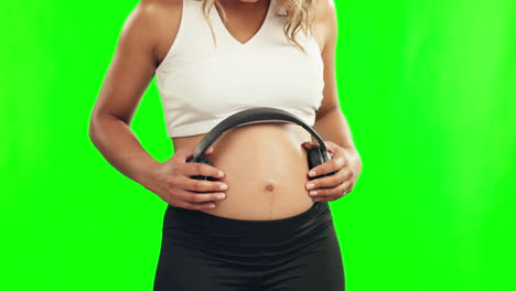 hands, pregnant woman or headphones on stomach